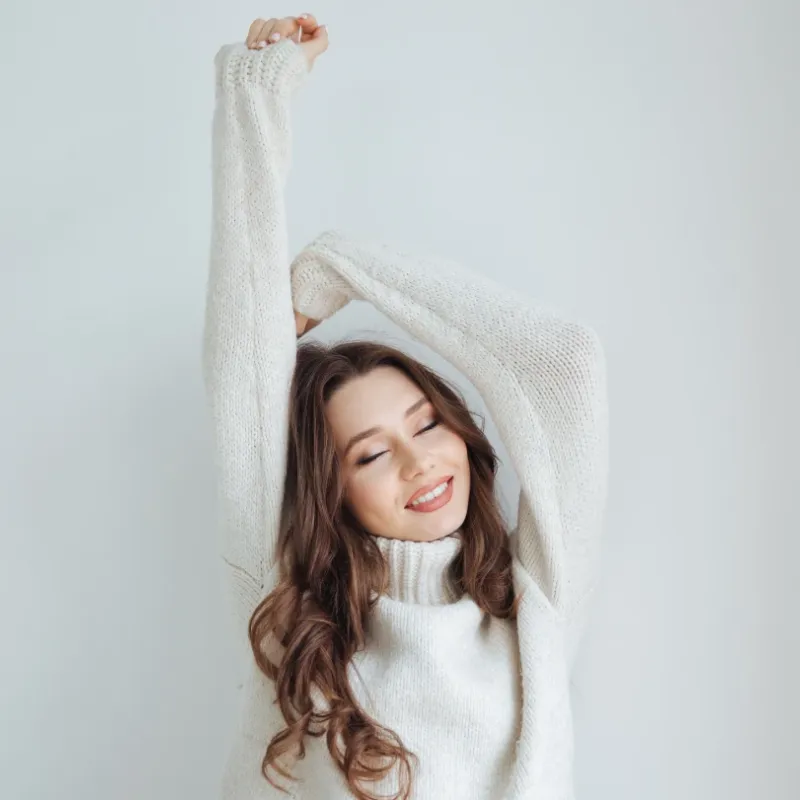 A happy woman feeling well stretching.