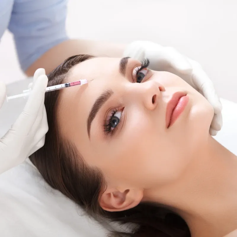 Woman receiving a nuerotoxin injection for skin tightening.