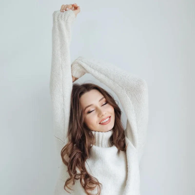 A happy woman feeling well stretching.