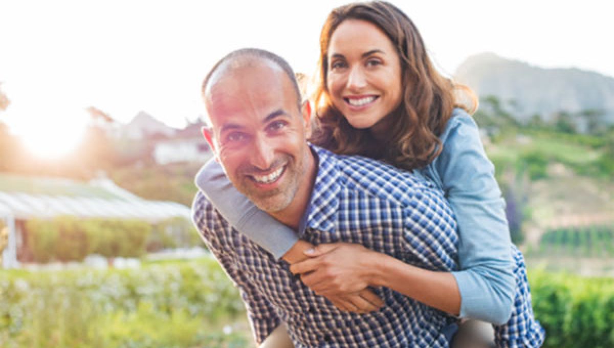 Couple enjoying playing outside together.